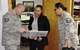 De’Lena Prentiss (center), 452d Operational Support Squadron, Airfield Ops assumes control of communication material provided by Tech. Sgt. Edwin Negron, 912th Air Refueling Squadron and Master Sgt. Kalikala Jugas, 452d Operational Support Squadron. The material will be signed for and kept in a secure location until aircrews are ready to retrieve it  (U.S. Air Force photo by Darnell Gardner)