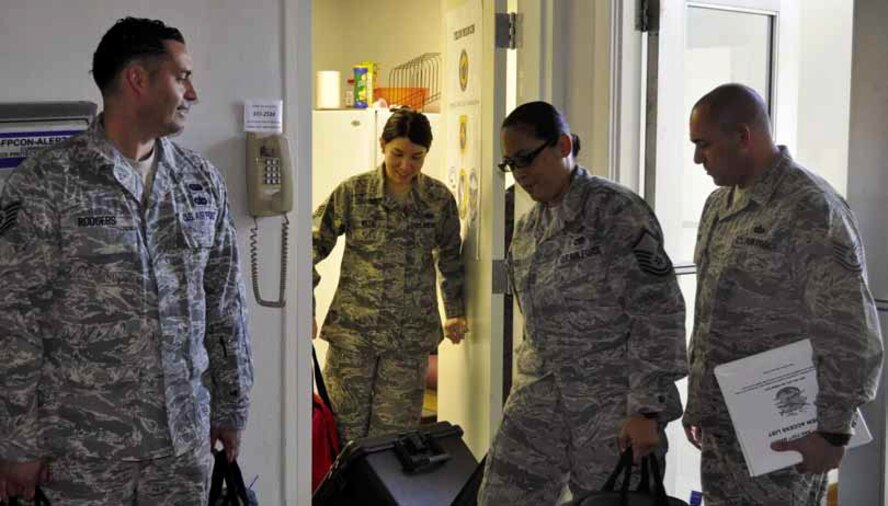 Combat Crew Communication personnel from the left, Tech. Sgt. Billy Rodgers, 452d
Operational Support Squadron, Staff Sgt. Jennifer Willig, 912th Air Refueling Squadron, Master Sgt. Kalikala Jugas, 452d OSS and Tech. Sgt. Edwin Negron, 912th ARS, transport communication material to receiving officers for issuing to outgoing aircrews. The March Air Reserve Base Integrated Combat Crew Communications has a unique mixture of Reserve and active duty personnel. (U.S. Air Force photo by Darnell Gardner)
