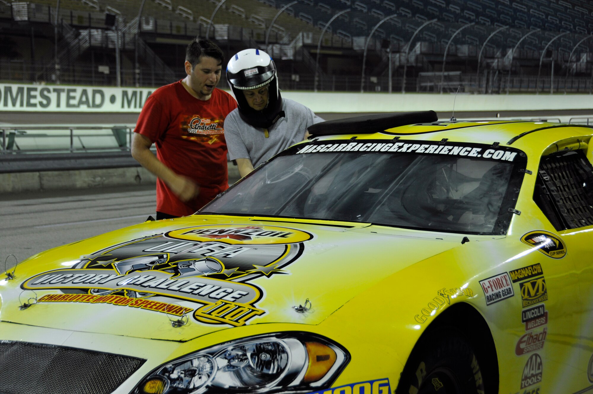 Thomas Jalbert crams into the passenger seat of a NASCAR stock car at the Homestead-Miami Speedway Feb. 23. Airmen from Homestead Air Reserve Base, Fla., participated in the NASCAR Racing Experience in support of the Single Airman Initiative. During the event, Airmen took laps around the Speedway along with a professional racing instructor. The Single Airman Initiative is a program for all local servicemembers, regardless of rank, service, or marital status, to participate in several community events, to include airboat tours of the Florida Everglades and scuba diving classes, which are free of charge. (U.S. Air Force photo/Senior Airman Nicholas Caceres)