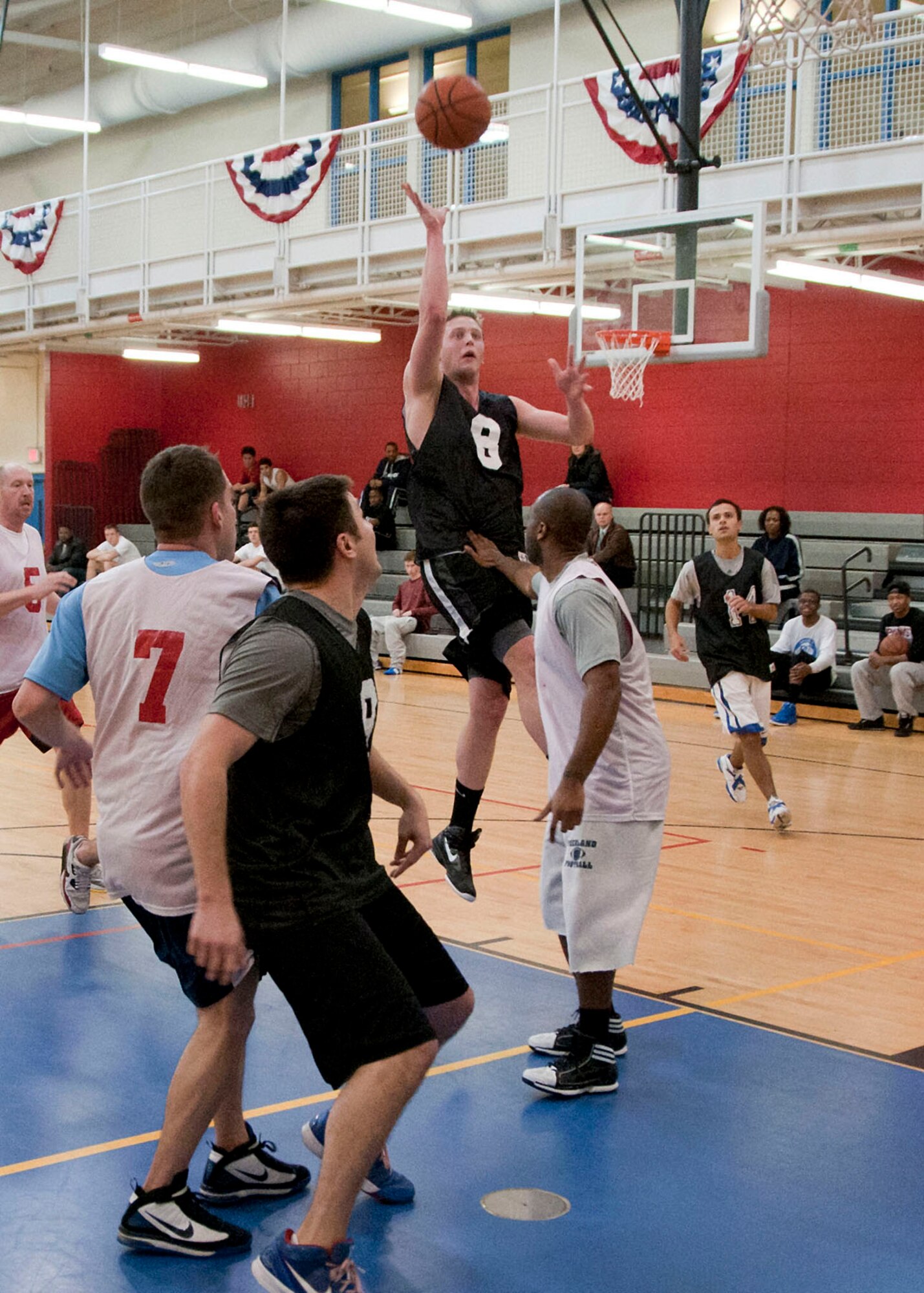 HANSCOM AIR FORCE BASE, Mass. -- Pat Hamilton, Air Force Life Cycle Management Center contracting specialist, drives to the basket during an intramural basketball game between AFLCMC Contracting and the Special Programs Division on Feb. 25 at the Hanscom Fitness and Sports Center. Contracting defeated Special Programs Division 49 to 34. Eight teams from across the base participate in the league that runs through April. (U.S. Air Force photo by Mark Wyatt)