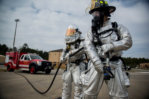 Two 23d Civil Engineer Squadron firefighters prepare to help extinguish a fire during a phase I operational readiness exercise Feb. 25, 2013, at Moody Air Force Base, Ga. OREs train and test the base’s ability to operate in a deployed environment. (U.S. Air Force photo by Staff Sgt. Jamal D. Sutter/Released)  