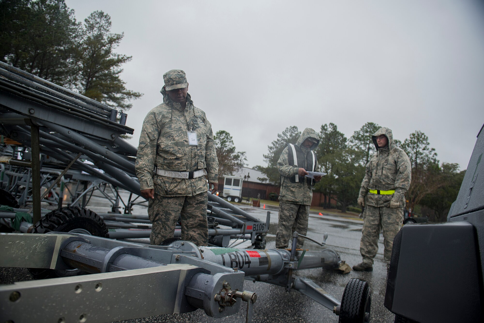 Dave Talley, 23d Logistics Readiness Squadron, U.S. Air Force Tech. Sgt. Jeremy Johnson, 23d LRS, and Airman 1st Class Nathan Waninger, 23d Equipment Maintenance Squadron, check cargo during a phase I operational readiness exercise Feb. 25, 2013, at Moody Air Force Base, Ga. The three were part of a cargo staging area that ensured pallets and cargo were properly built and labeled before transporting to aircraft. (U.S. Air Force photo by Staff Sgt. Jamal D. Sutter/Released) 
