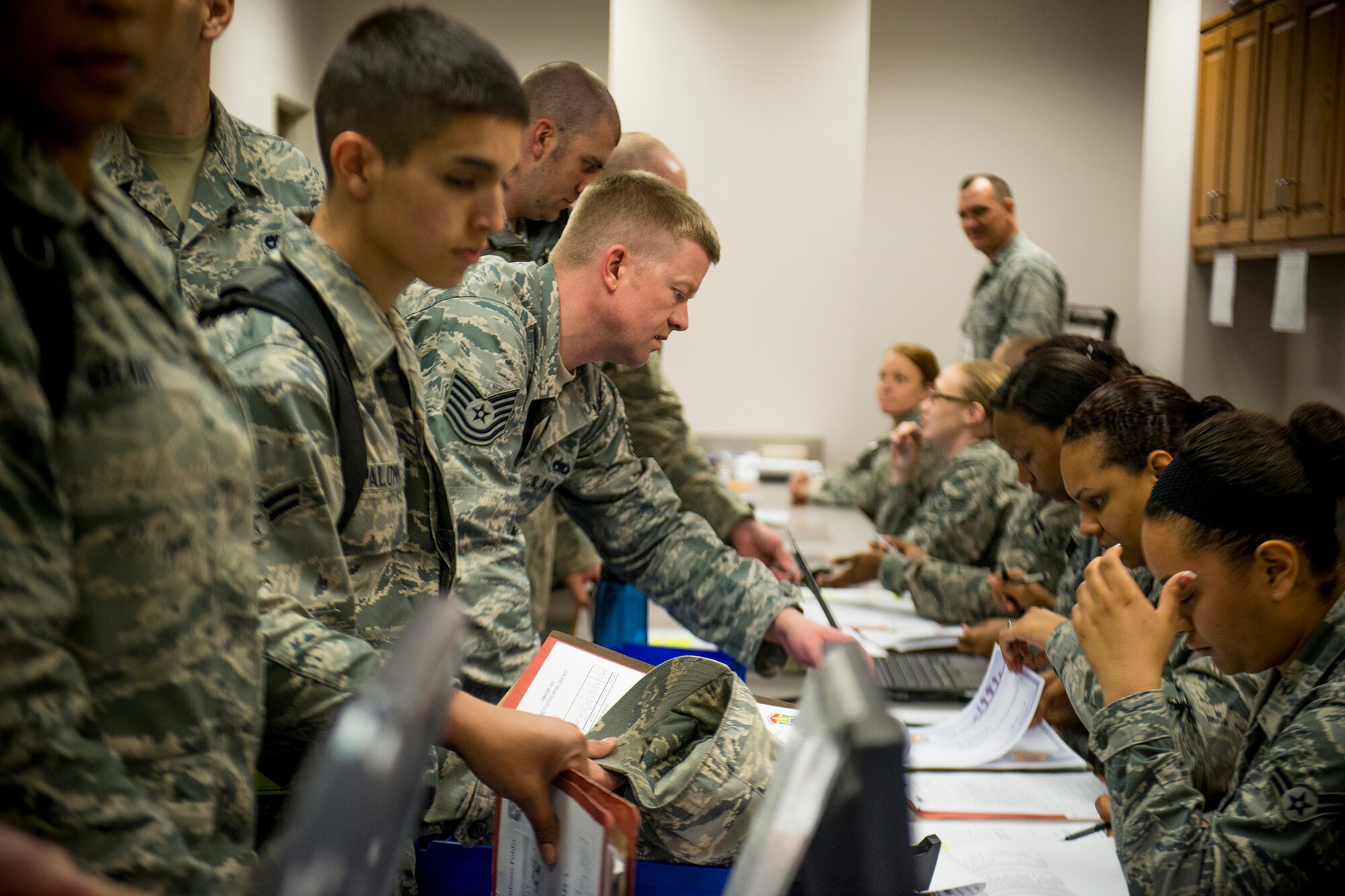 Members of the 23d Wing go through an out-processing line during a phase I operational readiness exercise Feb. 25, 2013, at Moody Air Force Base, Ga. The out-processing line was a last chance for Airmen to ensure their records were in order before deploying. (U.S. Air Force photo by Staff Sgt. Jamal D. Sutter/Released)
