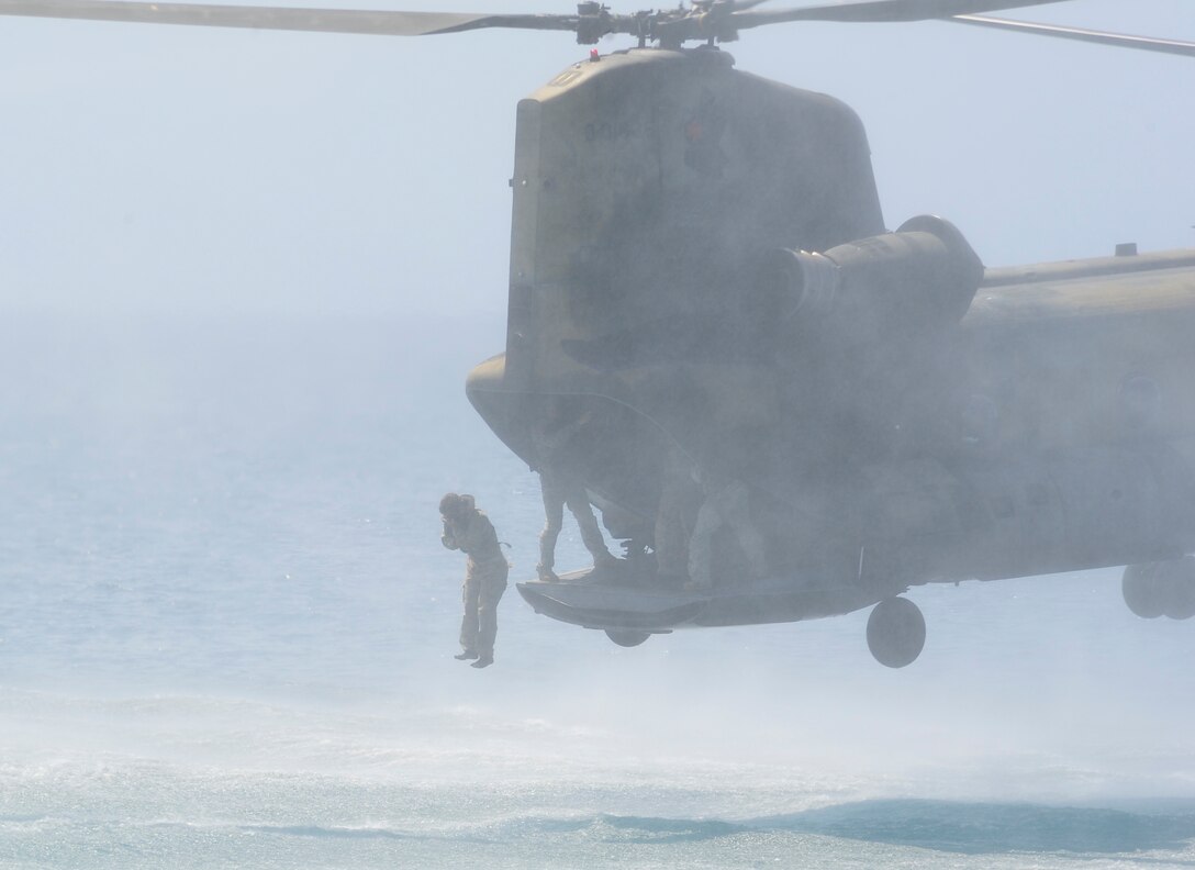 A U.S. special forces operator helocasts from the ramp of a CH-47, Feb. 15, 2013. Honduran Fuerza Especiales Naval and U.S. Naval Special Warfare operators partnered with the 1st Battalion, 228th Aviation Regiment from Joint Task Force-Bravo to conduct combined helocast and overwater hoist training.(Air Force photo/Capt. Rebecca Heyse)