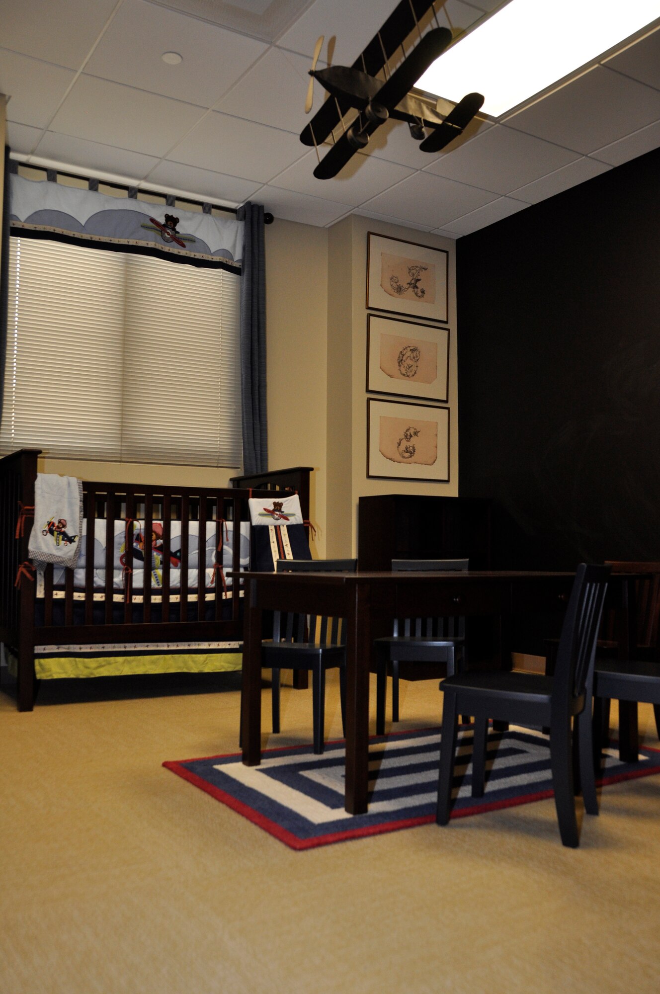 A children's room created for children of a fallen service member, was dedicated Feb. 25 during a ribbon-cutting ceremony at the new base chapel. The chapel annex is designed to accommodate families traveling to Dover to witness the dignified transfer of their loved one whose remains are returning to American soil. A chalkboard wall allows children to color or write messages to express themselves. (U.S. Air Force photo/Tech. Sgt. Ali Rose)