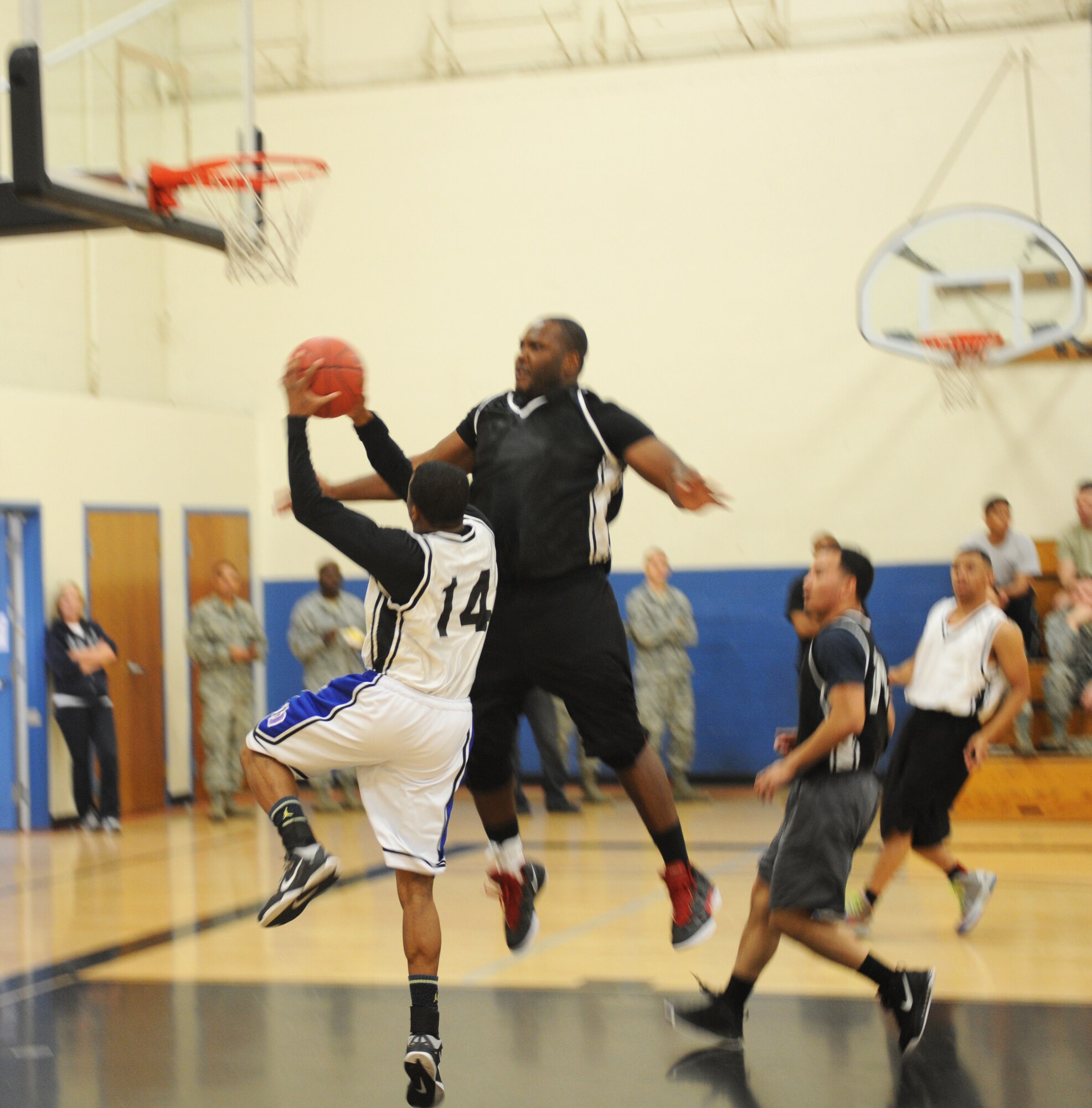 Senior Airman Alton White Jr., 9th Aircraft Maintenance Squadron shooting guard, attacks the basket against opponets of the 48th Intelligence Squadron during the Intarmural Basketball Championship at the Harris Fitness Center on Beale Air Force Base, Calif., Feb. 22. The 9th AMXS defeated the 48th IS 37-34. (U.S. Air Force photo by Airman 1st Class Bobby Cummings/Released)