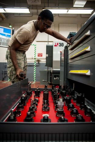 Airman 1st Class Tashma Antoine, 437th Maintenance Squadron aircraft metals apprentice, looks for the appropriate drill bit to be used on a computer operated mill Feb. 26, 2013, at Joint Base Charleston – Air Base, S.C. Antoine is assigned to the aircraft metals fabrication shop and is trained to use several different pieces of equipment to bend, cut and combine metals. Antoine is originally from Fort Myers, Fla. (U.S. Air Force photo/ Senior Airman Dennis Sloan)
