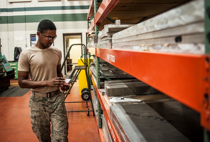 Airman 1st Class Tashma Antoine, 437th Maintenance Squadron aircraft metals apprentice, searches for a piece of scrap metal to be used in a computer operated mill machine Feb. 26, 2013, at Joint Base Charleston – Air Base, S.C. Antoine is assigned to the aircraft metals fabrication shop and is trained to use several different pieces of equipment to bend, cut and combine metals. Antoine is originally from Fort Myers, Fla. (U.S. Air Force photo/ Senior Airman Dennis Sloan)