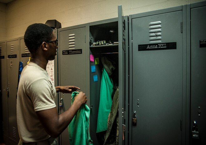 Airman 1st Class Tashma Antoine, 437th Maintenance Squadron aircraft metals apprentice, grabs his welding jacket from his locker Feb. 26, 2013, at the 437th MXS Metals Technology Shop. Antoine is assigned to the aircraft metals fabrication shop and is trained to use several different pieces of equipment to bend, cut and combine metals. Antoine is originally from Fort Myers, Fla. (U.S. Air Force photo/ Senior Airman Dennis Sloan)