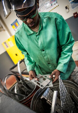 Airman 1st Class Tashma Antoine, 437th Maintenance Squadron aircraft metals apprentice, searches for a piece of scrap metal for a project Feb. 26, 2013, at Joint Base Charleston – Air Base, S.C. Antoine is assigned to the aircraft metals fabrication shop and is trained to use several different pieces of equipment to bend, cut and combine metals. Antoine is originally from Fort Myers, Fla.  (U.S. Air Force photo/ Senior Airman Dennis Sloan)