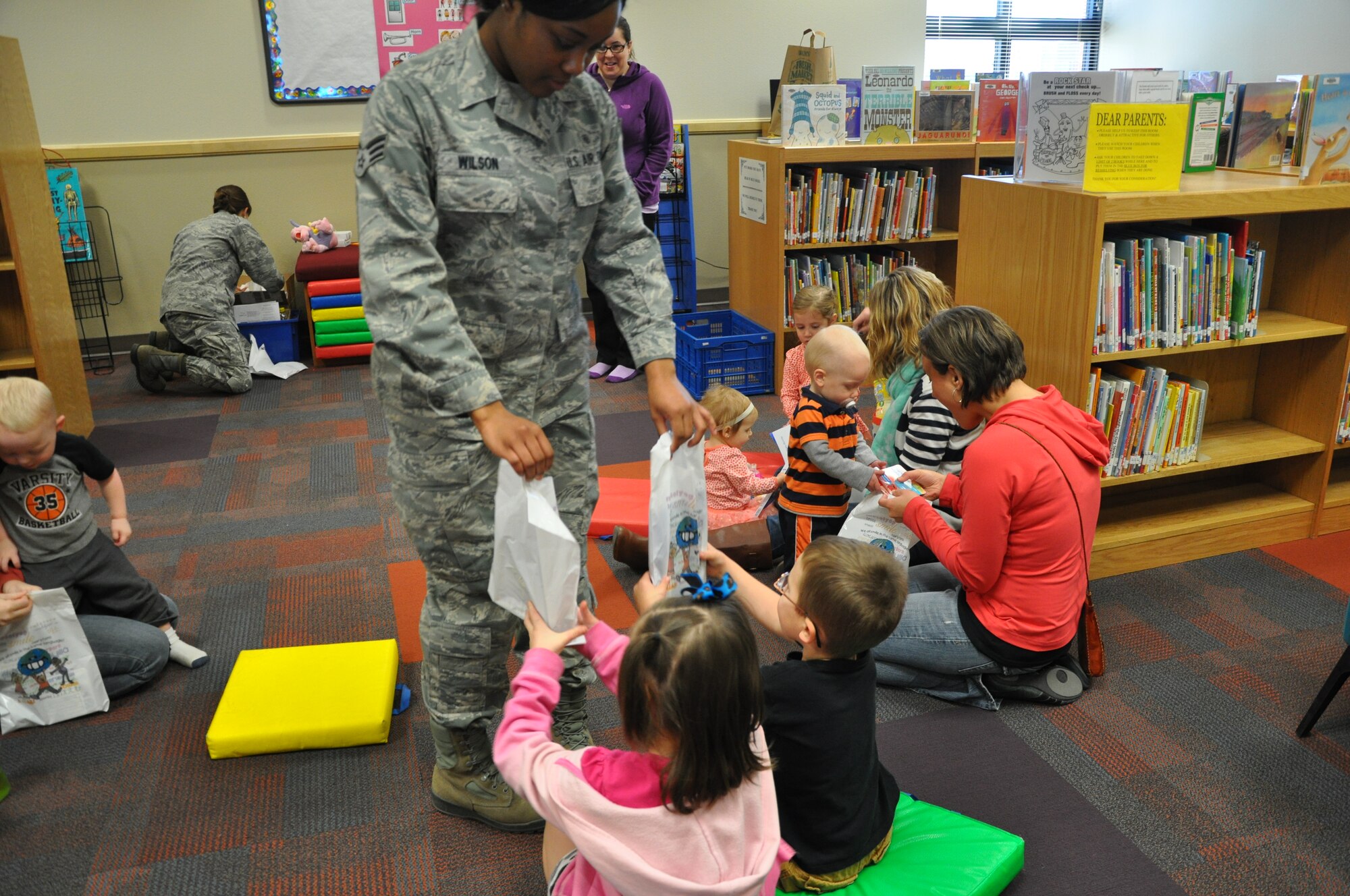 GOODFELLOW AIR FORCE BASE, Texas- Children receive packets containing various dental health items from Senior Airman Tiffany Wilson, 17th Medical Operations Squadron dental assistant, at the Consolidated Learning Center, Feb. 27. The packets were given out as part of the dental health presentation given by members from the 17th MDOS to raise awareness for Children’s Dental Health month. (U.S. Air Force photo/ Airman 1st Class Erica Rodriguez)