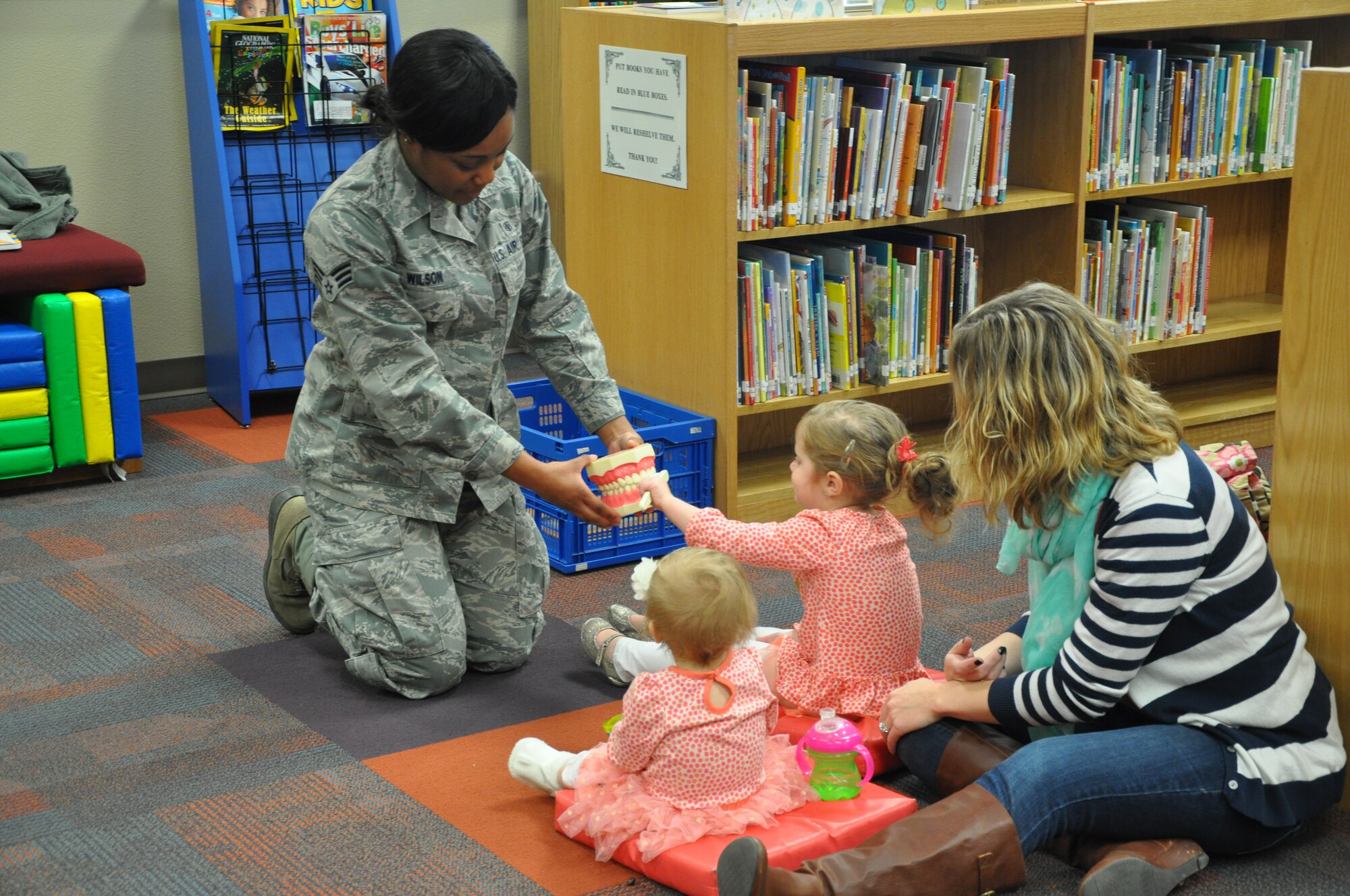 GOODFELLOW AIR FORCE BASE, Texas- Senior Airman Tiffany Wilson, 17th Medical Operations Squadron dental assistant, shows one of the children at the dental health presentation how to brush teeth at the Consolidated Learning Center here, Feb. 27. The members from the 17th MDOS gave the presentation as part of raising awareness for Children’s Dental Health month. (U.S. Air Force photo/ Airman 1st Class Erica Rodriguez)
