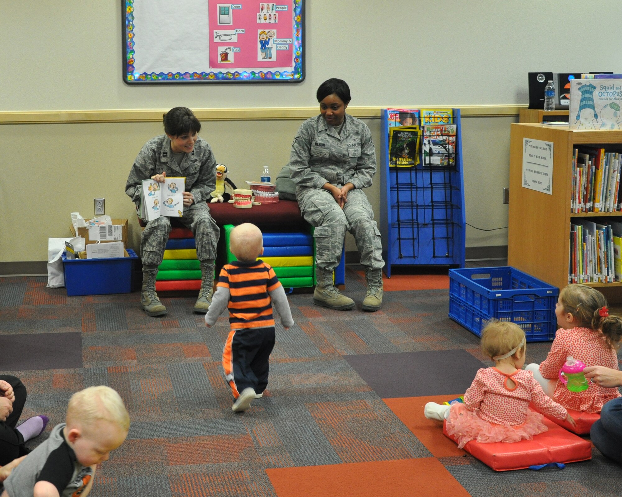 GOODFELLOW AIR FORCE BASE, Texas- Capt. Abbey Vinall, 17th Medical Operations Squadron dentist, reads a story about losing teeth to children at the Consolidated Learning Center here, Feb. 27. Members from the 17th MDOS held a presentation where they read stories and talked about the changes children’s teeth undergo for Children’s Dental Health month. (U.S. Air Force photo/ Airman 1st Class Erica Rodriguez)
