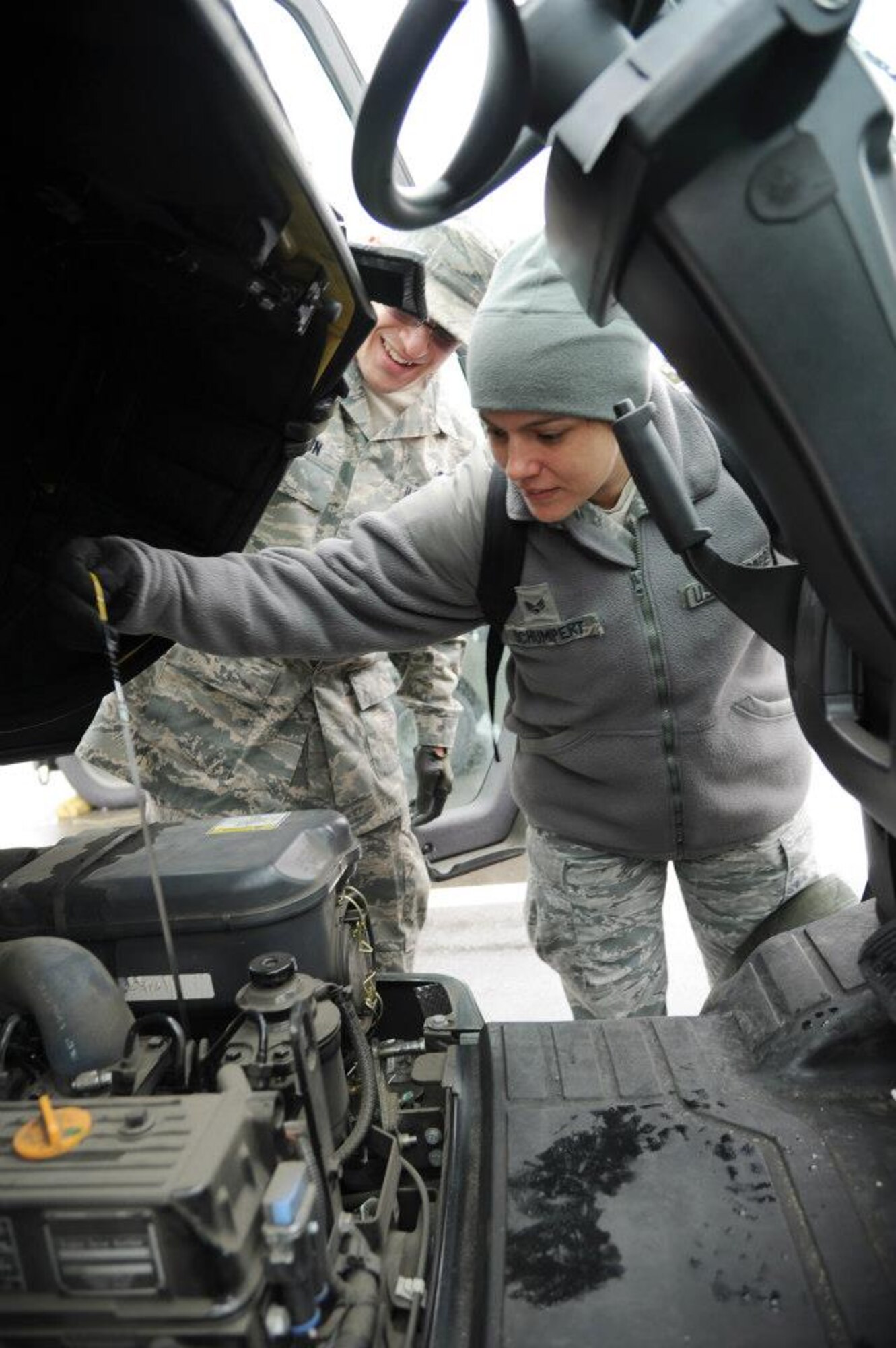 YOKOTA AIR BASE, Japan -- Senior Airman Stacy Schumpert, 927th Logistics Readiness Squadron, and Senior Airman Matchel Brown, 374th LRS, perform a routine inspection on a forklift February 19, 2013 at Yokota Air Base, Japan. Schumpert is a reservist participating in annual training, and spent two weeks working alongside her active-duty counterparts at the 374th LRS. Her Reserve unit is based at MacDill Air Force Base, Fl. (Official U.S. Air Force photo/Staff Sgt. Jannie Chamberlin) 
