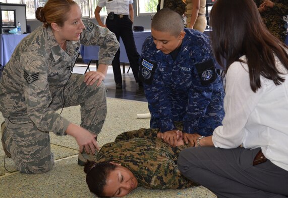 Staff Sgt. Autumn Clark gives step-by-step instructions to a member of the Salvadoran Air Force on the techniques to subdue and restrain a suspect, played here by a fellow classmate from the Salvadoran army. This instruction was part of a week long exchange of expertise in security and law enforcement between female members of the New Hampshire National Guard's security forces squadron and female members of the Salvadoran police and military from February 4th through 8th, 2013, at the Center for Military Education and Doctrine, San Salvador, El Salvador. (National Guard photo by 1st Lt. Alec Vargus/released)