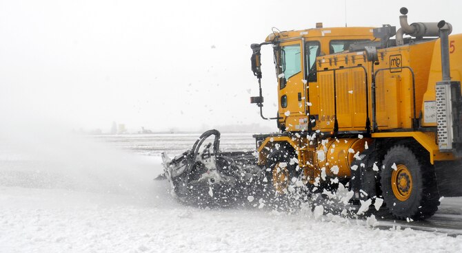 A snow broom from the 92nd Civil Engineer Squadron clears snow at Fairchild Air Force Base, Wash., Feb. 25, 2013. There are three different types of trucks used for snow removal which are snow plows, snow blowers and snow brooms. (U.S. Air Force photo by Airman 1st Class Ryan Zeski)
