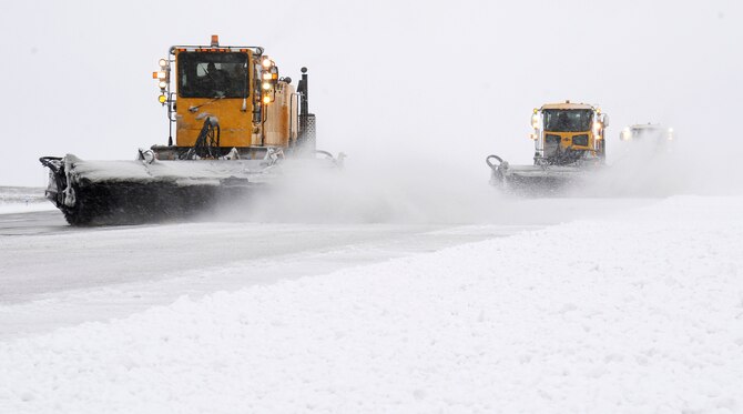 Members from the 92nd Civil Engineer Squadron clear snow from the runway using a vehicle known as a snow broom at Fairchild Air Force Base, Wash., Feb. 25, 2013. On an average day, it can take up to nine hours or more to remove the snow depending on the conditions. (U.S. Air Force photo by Airman 1st Class Ryan Zeski)