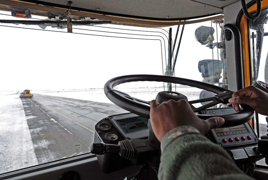 Senior Airman Steven Lowe, 92nd Civil Engineer Squadron snowman, clears snow from the runway at Fairchild Air Force Base, Wash., Feb. 25, 2013. The snow-removal team consists of 64 people with the help of 20 augmentees. (U.S. Air Force photo by Airman 1st Class Janelle Patiño)


