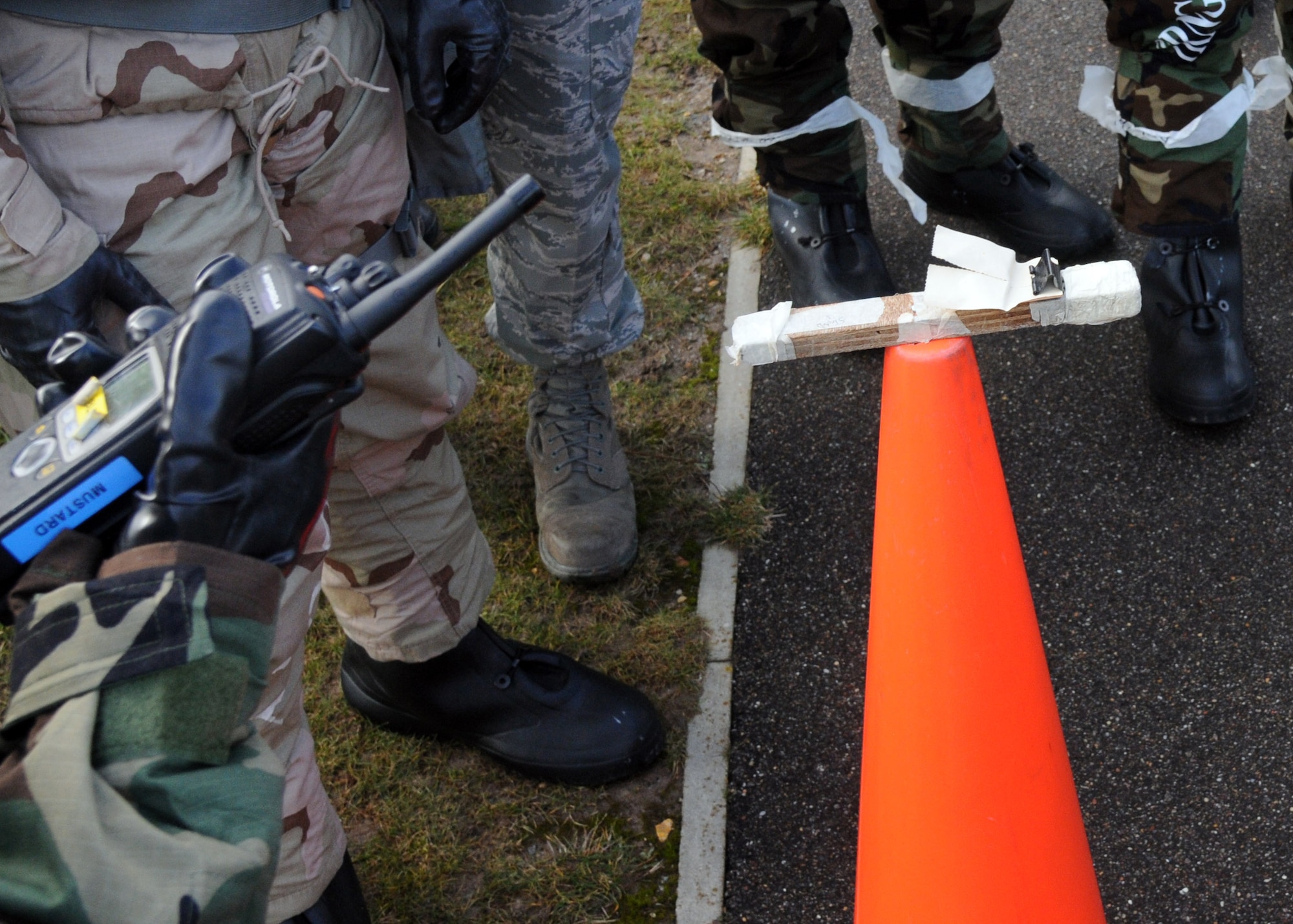 Airmen inspect simulated M-9 paper during their chemical, biological, radiological and nuclear training Feb. 7, 2013, in outside building 680 at RAF Mildenhall, England. The Airmen checked the paper for changes in color to determine if there are chemical agents in the air. 