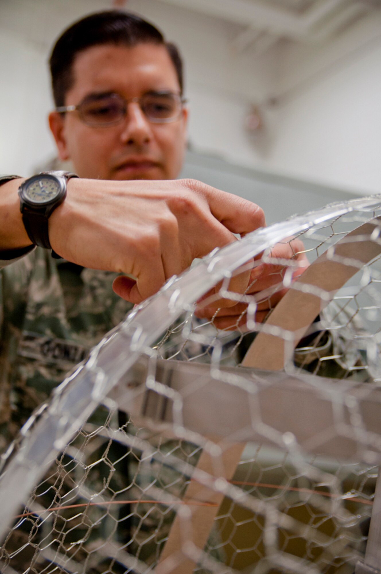 YOUNGSTOWN AIR RESERVE STATION, Ohio -- U.S. Air Force Reserve Tech. Sgt. Donald M. Gonzales, structural maintenance technician with the 910th Maintenance Squadron here, works on a unique project Jan. 16, 2013 at the paint shop here. Gonzales, a native of Valley City and Airman with the 910th Airlift Wing for approximately 13 years, is building a scale C-130 nose mock-up that will hang inside the C-130 Bar and Grille at the Community Activity Center here. U.S. Air Force photo by Tech. Sgt. Brenda Cosola