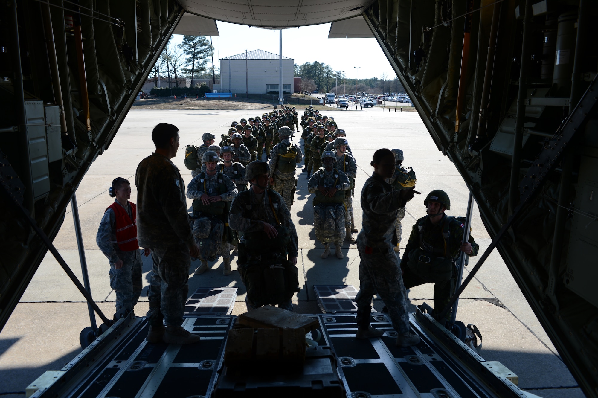 U.S. Soldiers with the 82nd Airborne Division and Canadian soldiers with the Royal Canadian Regiment prepare to board a U.S. Air Force C-130J Hercules aircraft for a static line airdrop during Joint Operational Access Exercise (JOAX) 13-02 at Fort Bragg, N.C., Feb. 24, 2013. A JOAX is designed to enhance cohesiveness between U.S. Army, Air Force and allied personnel, allowing the services an opportunity to properly execute large-scale heavy equipment and troop movement. (U.S. Air Force photo by Tech. Sgt. Jason Robertson/Released)
