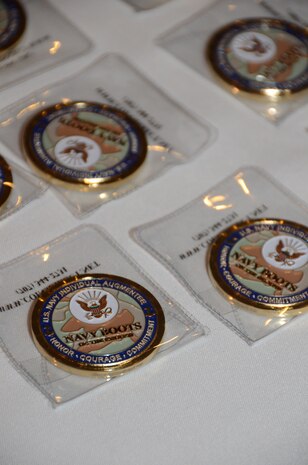 "Boots on Ground" command coins are laid out for Navy CAPT. Tom Bailey, Joint Base Charleston Deputy commander, to present to returning Navy Individual Augmentees during the inaugural IA Appreciation Luncheon  Feb. 15, 2013,  at the Redbank Club at JB Charleston – Weapons Station, S.C.  . Individual Augmentees perform duties outside of standard Navy platforms alongside Soldiers, Marines and Airmen world-wide. (U.S. Navy photo/Petty Officer 1st Class Chad Hallford)