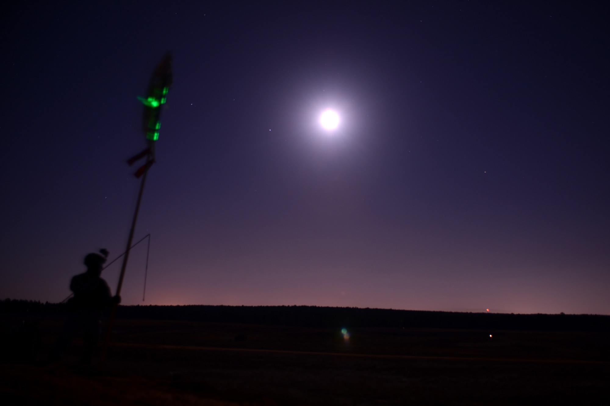U.S. Army 1st Lt. Phil Yandall, with the 1st Battalion, 508th Parachute Infantry Regiment, 4th Brigade Combat Team, 82nd Airborne Division, holds a signal indicating a rally point during Joint Operational Access Exercise (JOAX) 13-02 at Fort Bragg, N.C., Feb. 24, 2013. A JOAX is designed to enhance cohesiveness between U.S. Army, Air Force and allied personnel, allowing the services an opportunity to properly execute large-scale heavy equipment and troop movement. (U.S. Air Force photo by Tech. Sgt. Jason Robertson/Released)
