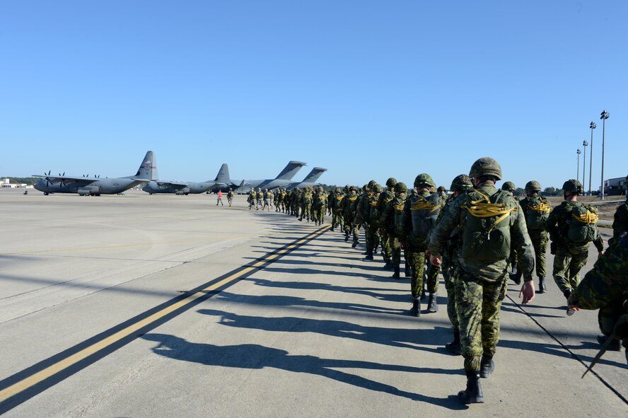 U.S. Soldiers with the 82nd Airborne Division and Canadian soldiers with the Royal Canadian Regiment prepare to board an aircraft for a static line airdrop during Joint Operational Access Exercise (JOAX) 13-02 at Fort Bragg, N.C., Feb. 24, 2013. A JOAX is designed to enhance cohesiveness between U.S. Army, Air Force and allied personnel, allowing the services an opportunity to properly execute large-scale heavy equipment and troop movement. (U.S. Air Force photo by Tech. Sgt. Jason Robertson/Released)
