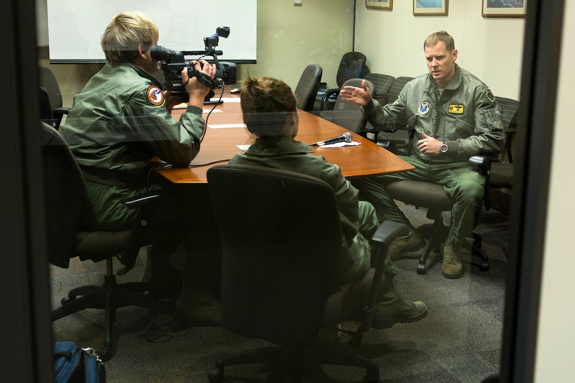 U.S. Air Force Lt. Col. William Wharton, 11th Bomb Squadron commander, is interviewed by KTAL Channel 6 News reporters Joel Rodgers and Leslie Draffin, Feb. 26, 2013, Barksdale Air Force Base, La. The reporters flew on a 93rd Bomb Squadron B-52H Stratofortress for a report on the mission of the B-52 Formal Training Unit at Barksdale. (U.S. Air Force photo by Master Sgt. Greg Steele/Released)
