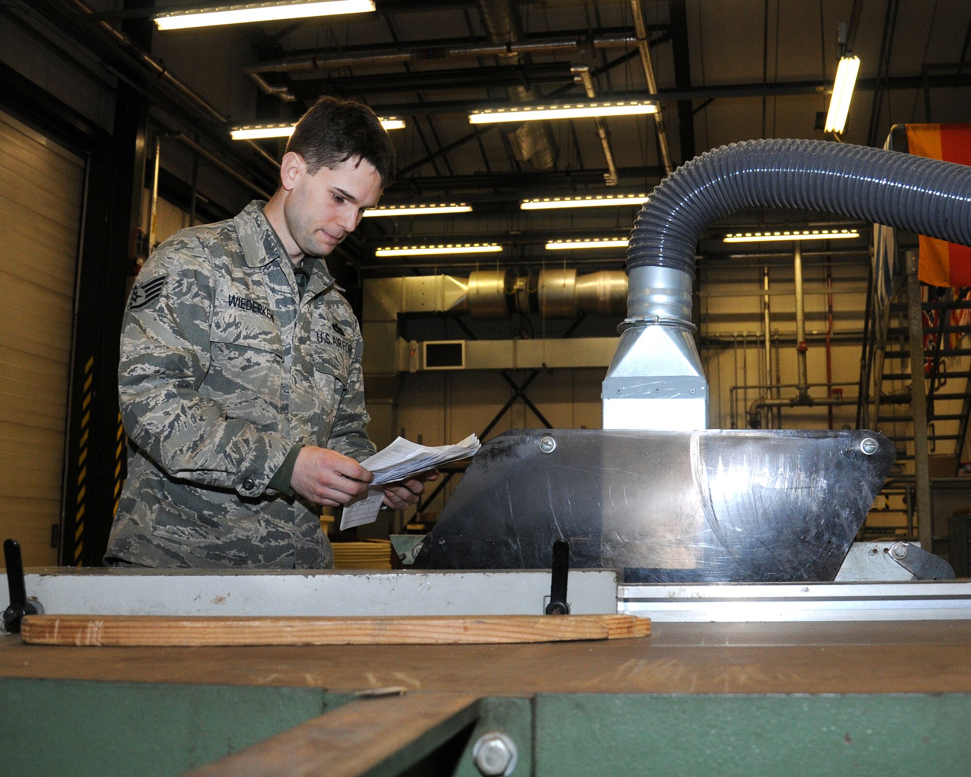 Staff Sgt. Filipi Wiederkehr, 100th Logistics Readiness Squadron traffic management craftsman from Sao Paulo, Brazil, performs a daily update inspection on saws and machinery equipment and signs an Air Force Technical Order form 244 on Feb. 22, 2013, at RAF Mildenhall, England. The 100th LRS Cargo Movement Section had zero write-ups during the last Logistics Compliance Assessment Program Inspection. (U.S. Air Force photo by Gina Randall/Released)