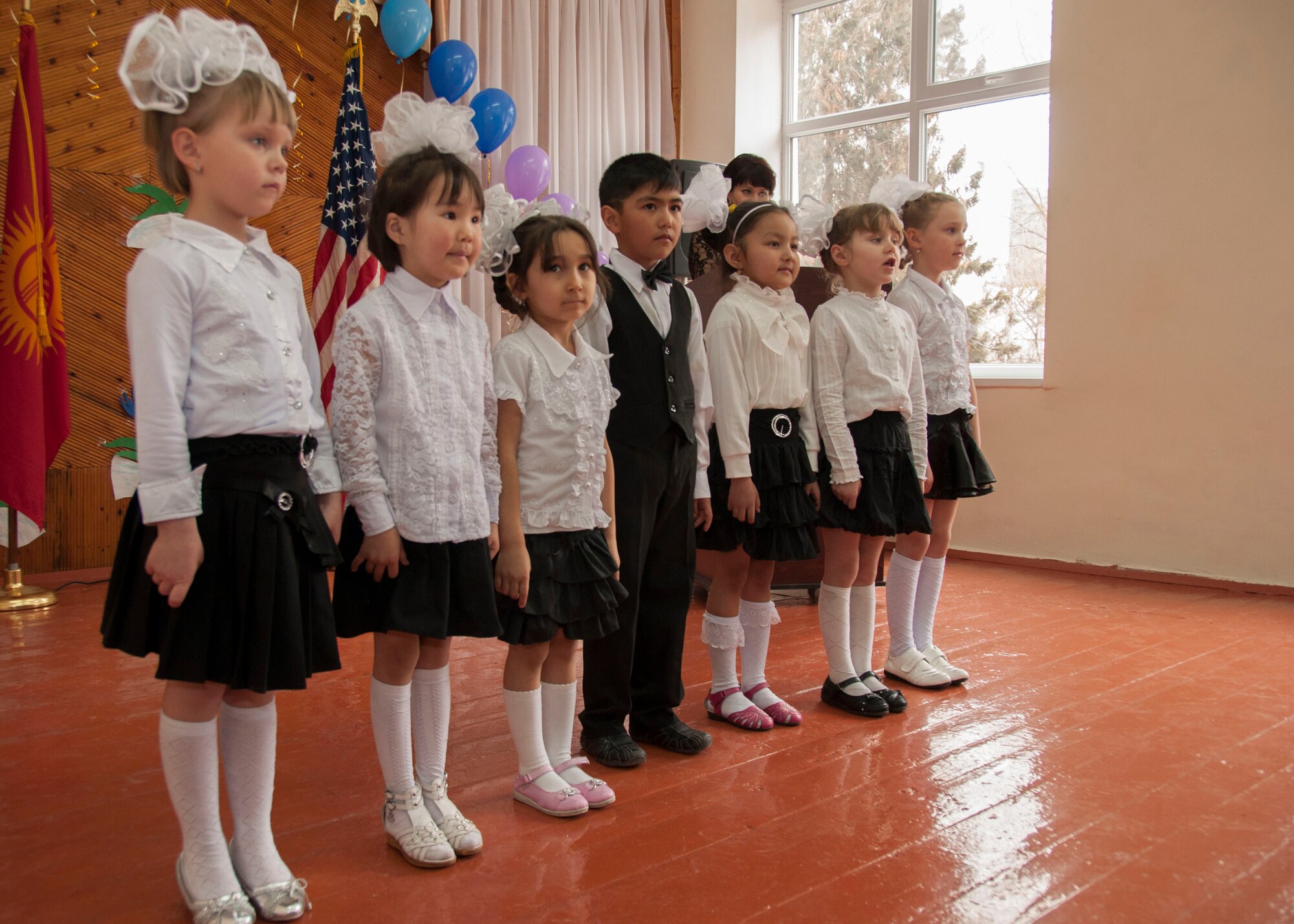 Children perform a song during a dedication ceremony to celebrate renovations at the Vasilievskoe Kindergarten School in Vasilievskoe, Kyrgyzstan, Feb. 26, 2013. Four times as many children can enroll in the kindergarten now that the school building has been completely renovated. (U.S. Air Force photo/Tech. Sgt. Rachel Martinez)