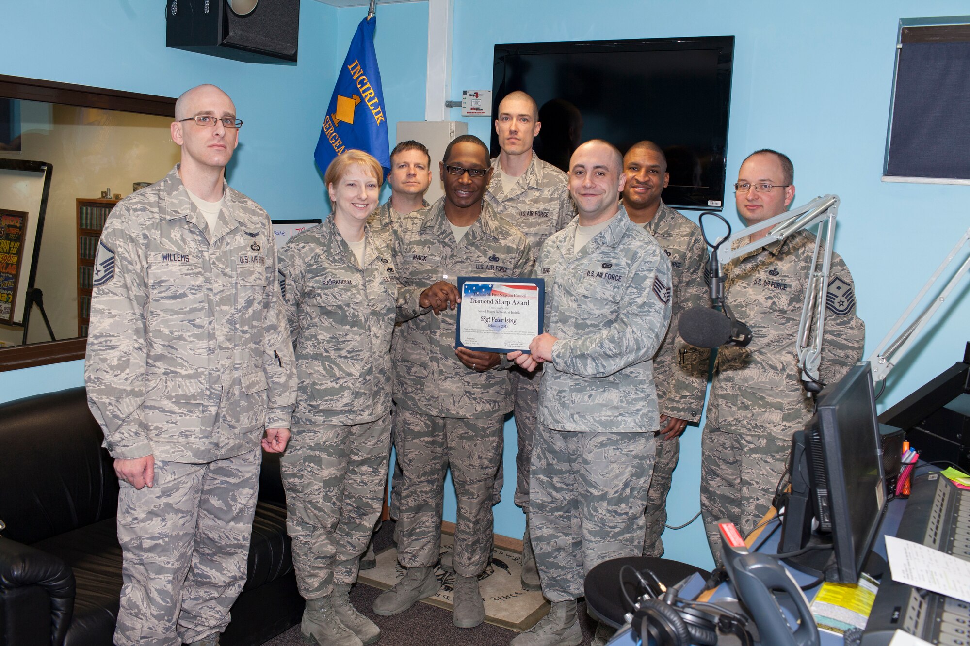 Staff Sgt. Peter Ising Jr., American Forces Network-Incirlik NCO in charge of news, receives the Diamond Sharp award from the Incirlik First Sergeants group Feb. 27, 2013, at Incirlik Air Base, Turkey. Ising earned the monthly award by distinguishing himself through outstanding professionalism, performance and display of the Air Force core values. (U.S. Air Force photo by Master Sgt. Lee Hoover Jr./Released)
