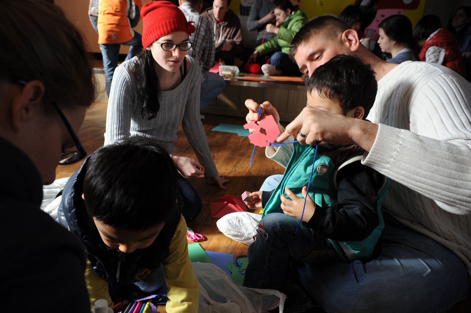 Airmen from Osan Air Base, Republic of Korea, do arts and crafts with children from the Aehyang Orphanage in Pyongtak-si, ROK, Feb. 23, 2013. Members of Osan’s Chapel get volunteers together once a month to visit an orphanage in the local area to spend time with the children and try to give back to the community. (U.S. Air Force photo/Staff Sgt. Sara Csurilla) 