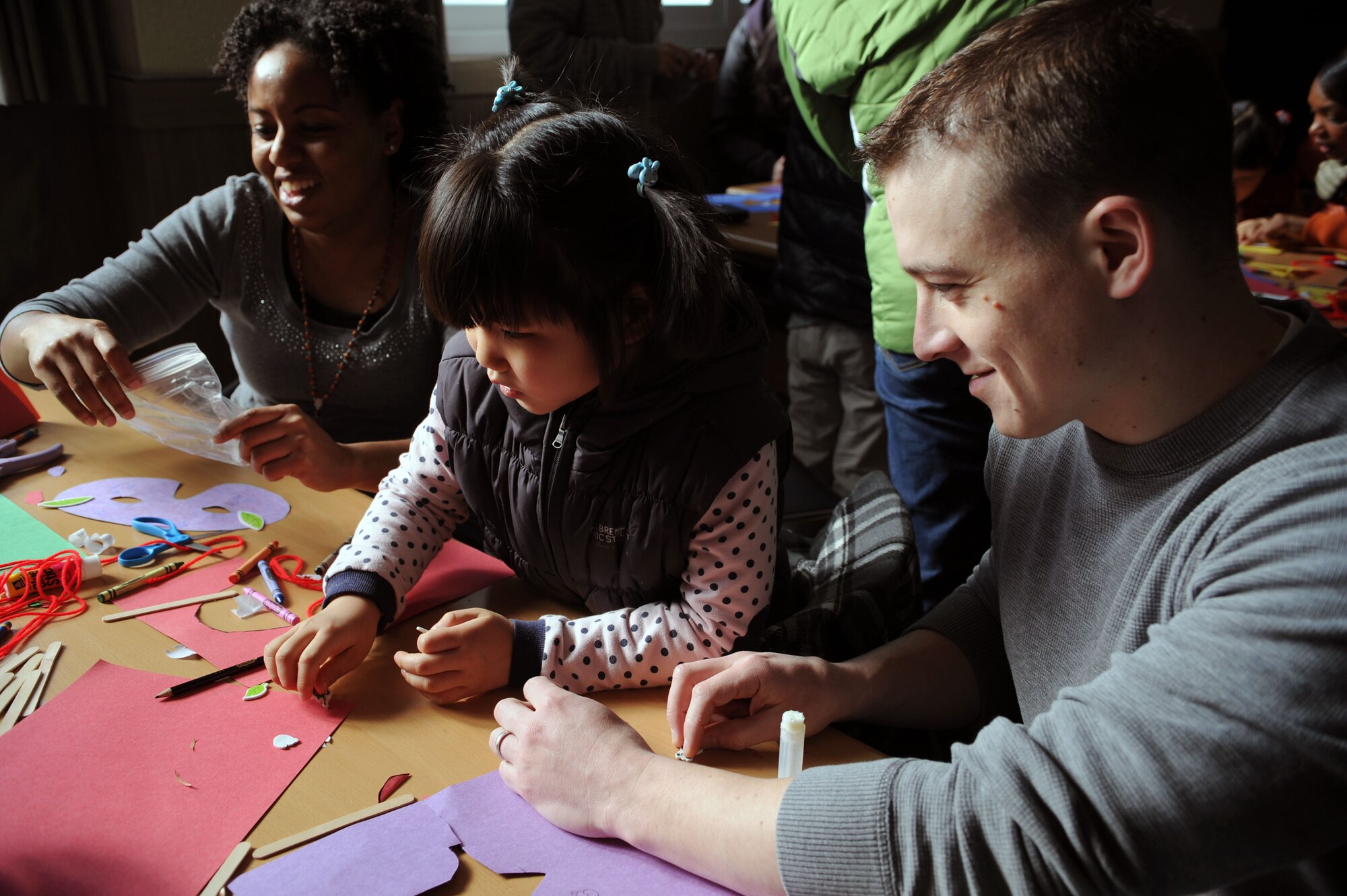 Airmen from Osan Air Base, Republic of Korea, do arts and crafts with children from the Aehyang Orphanage in Pyongtak-si, ROK, Feb. 23, 2013. Members of Osan’s Chapel get volunteers together once a month to visit an orphanage in the local area to spend time with the children and try to give back to the community. (U.S. Air Force photo/Staff Sgt. Sara Csurilla) 