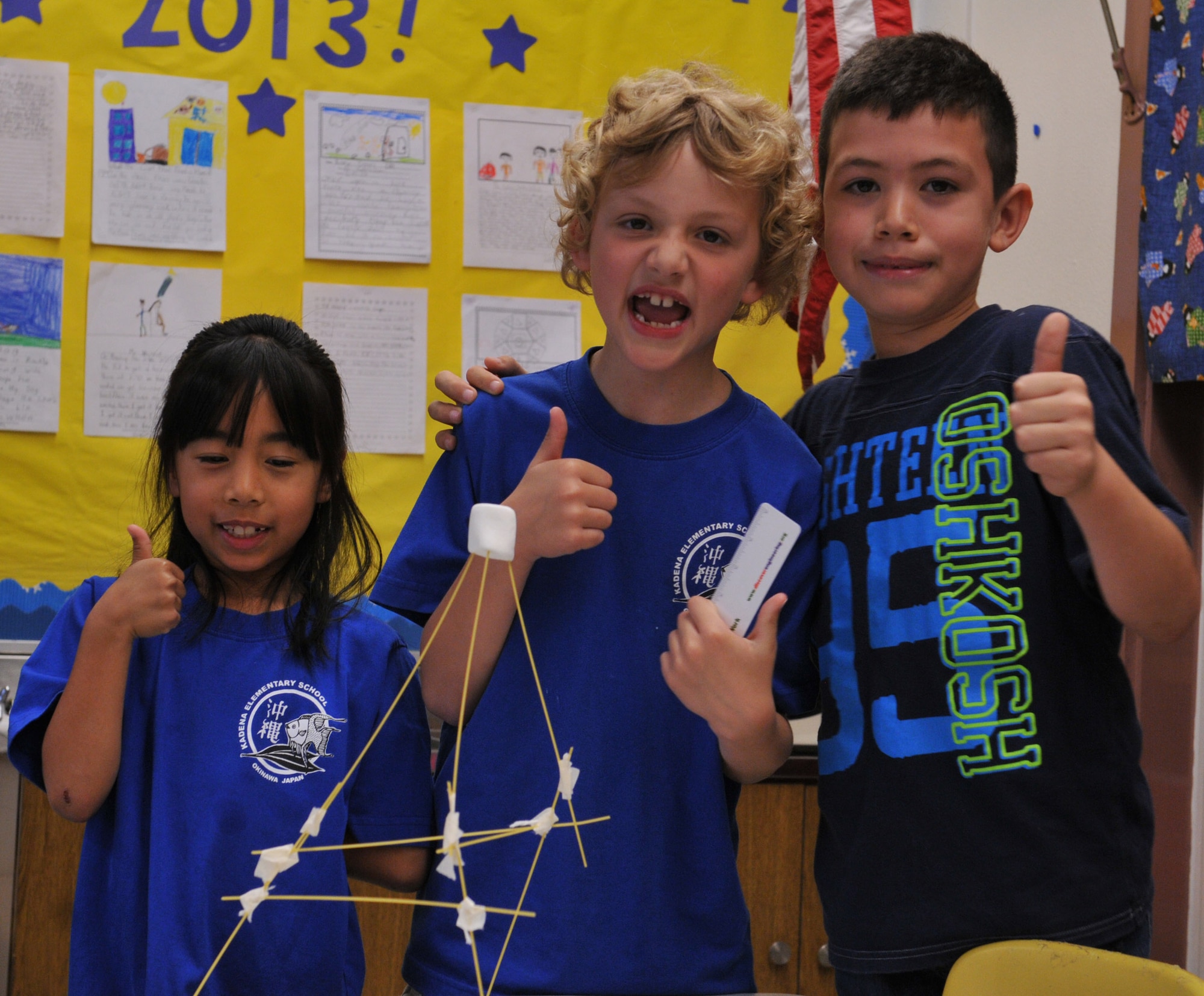 Kadena Elementary School 2nd graders celebrate building the biggest tower in their class on Kadena Air Base, Japan, Feb. 22, 2013. Students were allotted 18 minutes to construct a structure using spaghetti noodles, tape and a marshmallow. The 2nd graders built a 39-inch tower by using teamwork, creating a plan and by communicating with each other to make that plan work. (U.S. Air Force photo/Airman 1st Class Keith A. James)