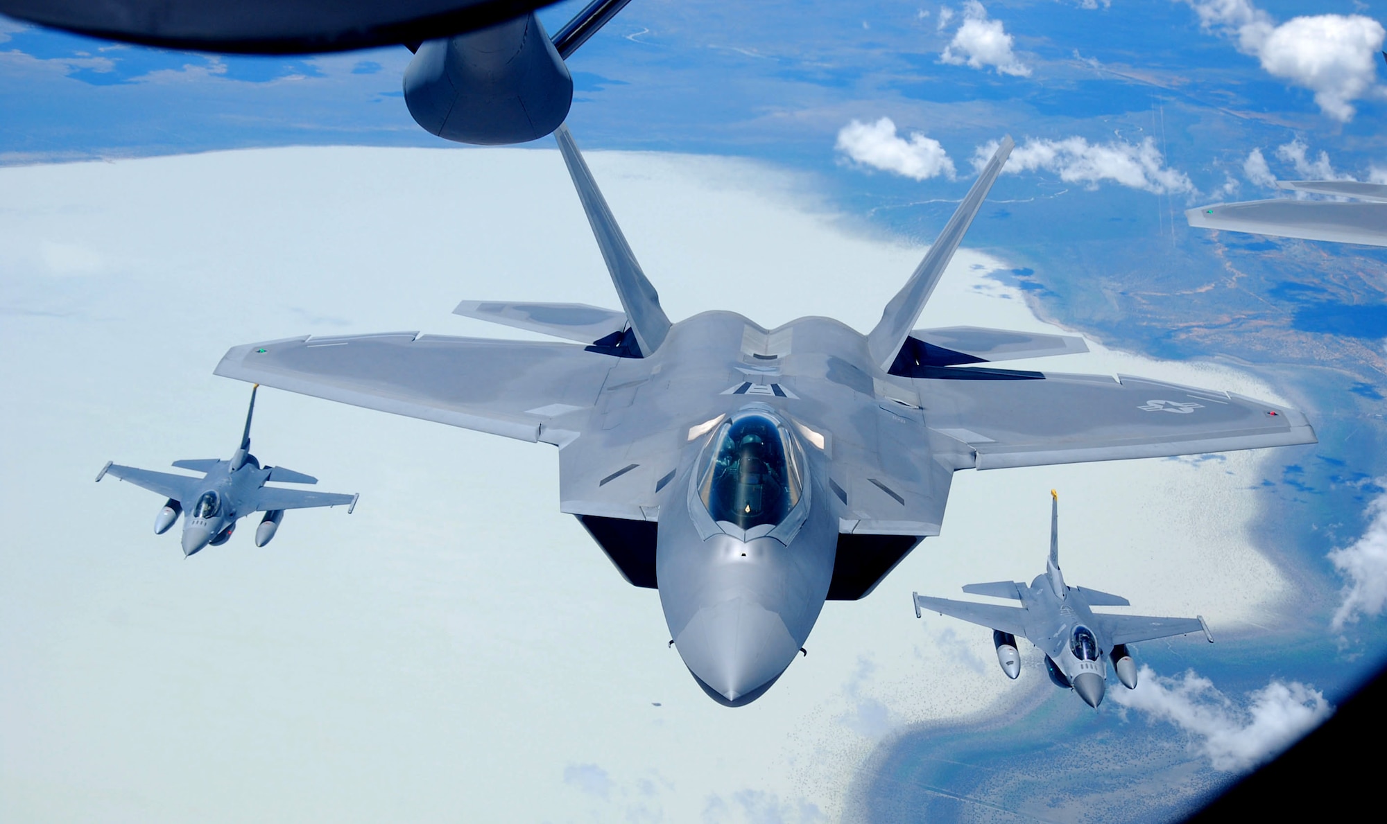 Flying behind a KC-135 Stratotanker from Kadena Air Base, Japan, an F-22 Raptor, representing the Langley Air Force Base, Va., demonstration team, and F-16 Fighting Falcons, representing the Misawa Air Base, Japan, demonstration team, enter Australian territory after refueling on Feb. 22, 2013. The jets are part of the Australian International Airshow 2013, which is scheduled from Feb. 26 to March 3. It is the largest biennial and international trade show in the Pacific. At the airshow, a cross-section of U.S. military aircraft and equipment are scheduled to be present through static displays and aerial demonstrations, including the United States Air Force’s F-22 Raptor, C-17 Globemaster III, F-16 Fighting Falcon, B-52 Stratofortress, and KC-135 Stratotanker. Approximately 220 U.S. service members are supporting AIA13, which represents a unique opportunity for the United States to showcase its aviation prowess and promote strong military-to-military ties with its Pacific allies and friends. (U.S. Air Force photo/Capt. Natassia Cherne)