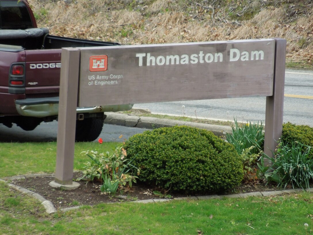 The brown Thomaston Dam sign let's visitor's know they have entered Corps' property Thomaston, Conn. Thomaston Dam is located on the Naugatuck River and is a part of a network of flood control dams and local protection projects built by the U.S. Army Corps of Engineers in the Naugatuck River Basin. The dam was constructed at a cost of $14.2 million and was completed in 1960 in response to the destructive flood of 1955. Thomaston Dam can store up to 13.7 billion gallons of water for flood risk management purposes.
