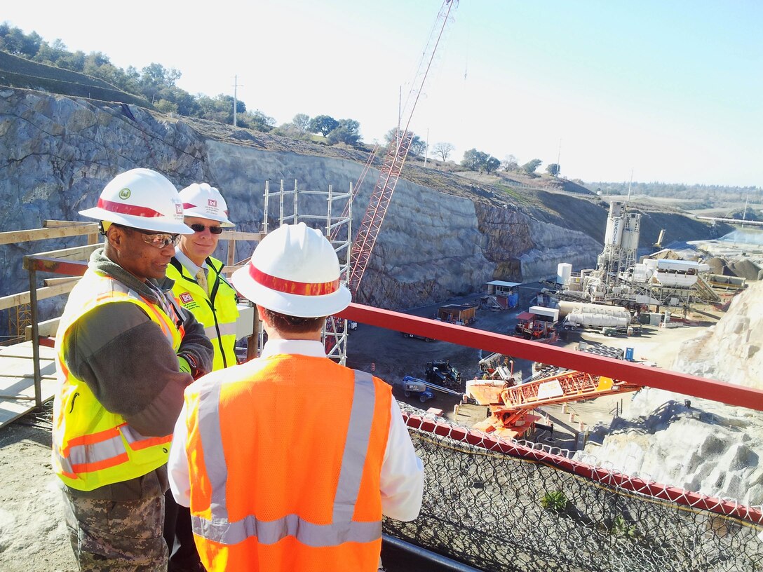 Commanding general of the U.S. Corps of Engineers, Lt. Gen. Thomas P. Bostick (left), tours the Folsom Dam auxiliary spillway construction site in Folsom, Calif., Jan. 16, 2013, led by the project’s director, David Thomas (middle). Also pictured: Nathan Dietrich (right), district director for U.S. Rep. Doris Matsui.  (U.S. Army photo by Capt. Michael N. Meyer/Released)