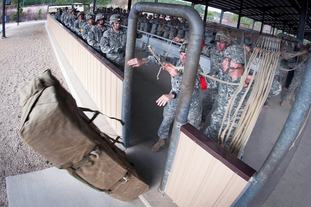 Army Lt. Col. Praxitelis Vamvakias pushes a door bundle from a mock door trainer that simulates the hold of a C-17 Globemaster aircraft before an airborne training exercise on Fort Bragg, N.C., Feb. 25, 2013. Vamvakias commands the 82nd Airborne Division’s  2nd Battalion, 504th Parachute Infantry Regiment, 1st Brigade Combat Team.