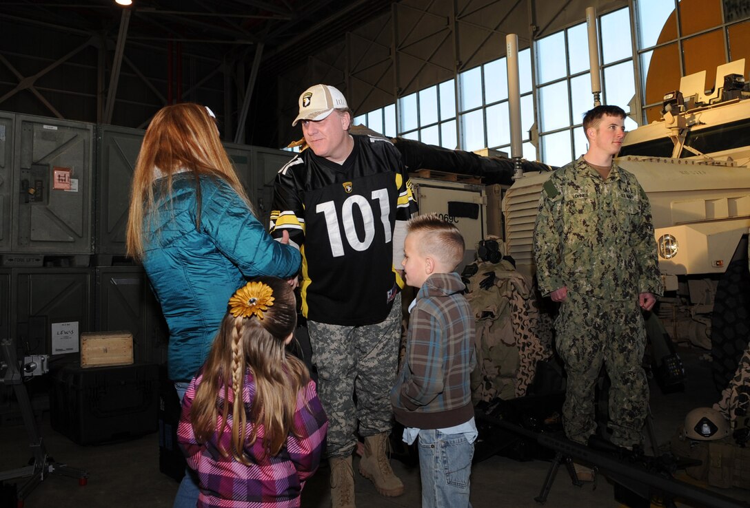 World Series-winning pitcher Curt Schilling talks with a military family on Naval Air Facility Rota, Spain, Feb. 26, 2013, after U.S. Navy Adm. James A. Winnefeld Jr, vice chairman of the Joint Chiefs of Staff, decorated three Naval Explosive Ordnance Disposal technicians with medals they earned during a recent deployment to Afghanistan. Schilling pitched for the Boston Red Sox during the series win in 2004.