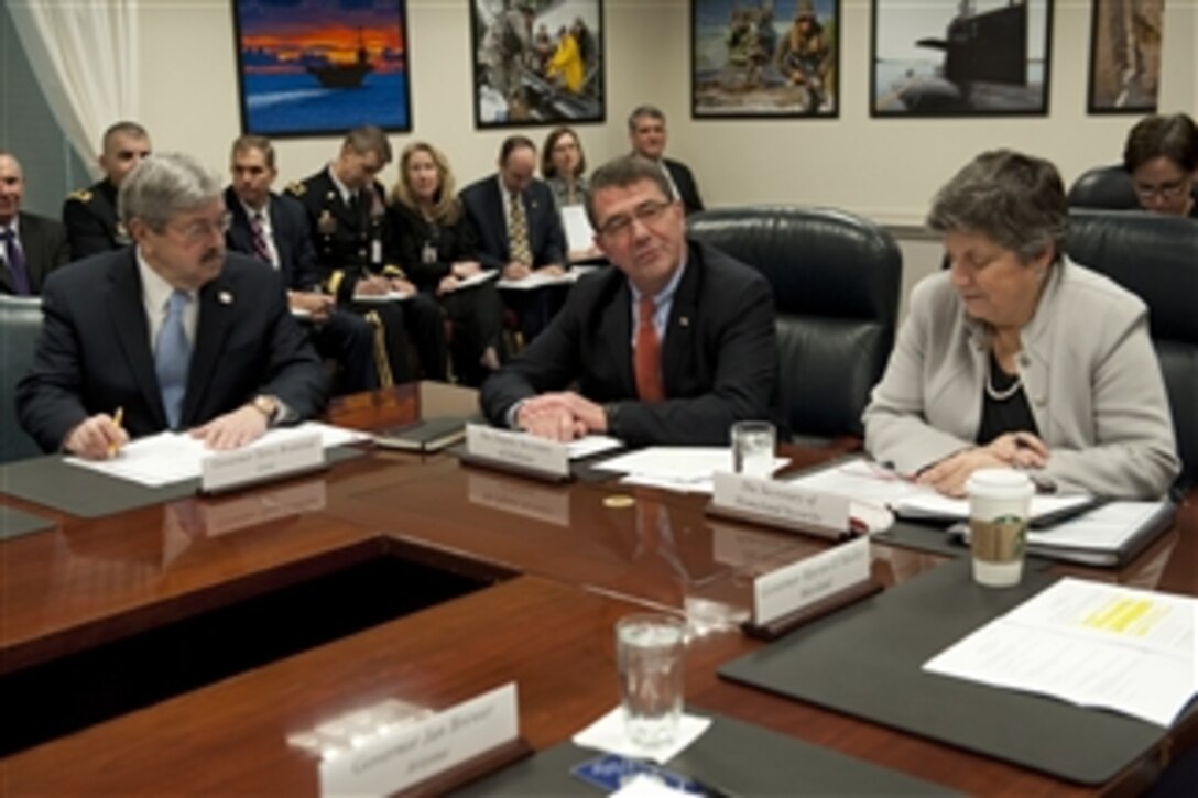 Iowa Gov. Terry E. Branstad, left, listens as Deputy Secretary of Defense Ashton B. Carter, center, and Secretary of Homeland Security Janet Napolitano, right, convene the meeting of the Council of Governors in the Pentagon on Feb. 25, 2013.  