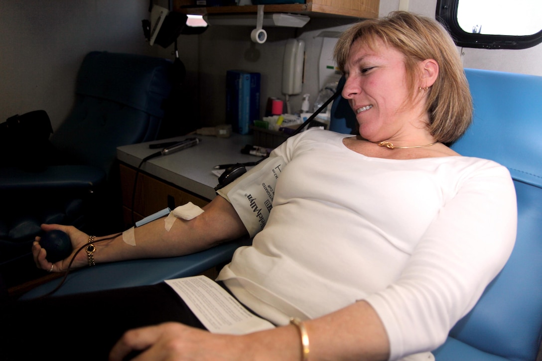 Lisa A. Good, Legal Services Support Team Freedom of Information Act and Privacy Act coordinator, squeezes a rubber ball while donating blood at the Armed Services Blood Program outside the Cherry Point Marine Corps Exchange Friday. The Armed Services Blood Program provides blood to many different military installations stateside and overseas.