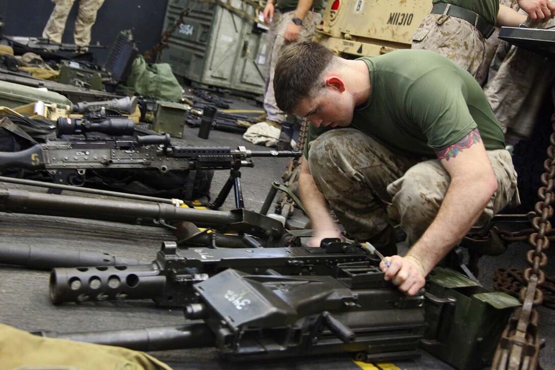 Lance Cpl. Ryan S. Sulzmann, machine-gunner, Combined Anti-Armor Team 1, Weapons Company, Battalion Landing Team 3/5, 15th Marine Expeditionary Unit, cleans crew-served weapons aboard the USS Rushmore, Feb. 19. The 15th MEU is deployed as part of the Peleliu Amphibious Ready Group as a U.S. Central Command theater reserve force, providing support for maritime security operations and theater security cooperation efforts in the U.S. 5th Fleet area of responsibility. (U.S. Marine Corps photo by Cpl. Timothy R. Childers/Released)