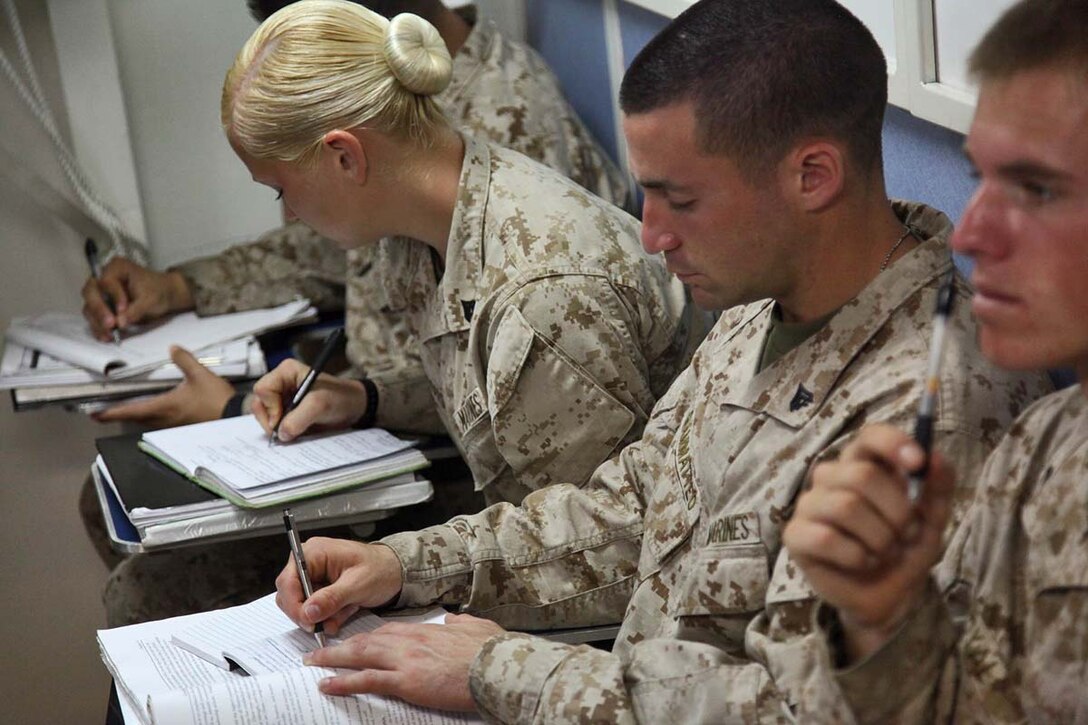 Marines assigned to the 15th Marine Expeditionary Unit, take notes during a Corporals Course leadership class aboard the USS Rushmore, Feb. 22. The 15th MEU is deployed as part of the Peleliu Amphibious Ready Group as a U.S. Central Command theater reserve force, providing support for maritime security operations and theater security cooperation efforts in the U.S. 5th Fleet area of responsibility. (U.S. Marine Corps photo by Cpl. Timothy R. Childers/ Released)