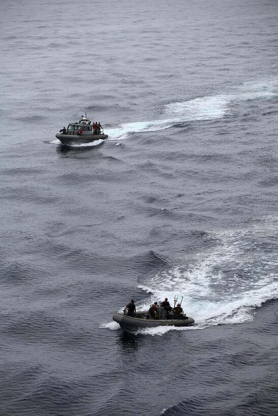 Marines assigned to Maritime Raid Force, Command Element, 15th Marine Expeditionary Unit and sailors assigned to the USS Rushmore conduct small-boat operations near the USS Rushmore, Feb. 25. Servicemembers took advantage of their time at sea to conduct Maritime Interoperability Training that touched on a number of areas the Marines were unfamiliar with, including at-sea casualty evacuations, small boat proficiency and live-fire gunnery training. The 15th MEU is deployed as part of the Peleliu Amphibious Ready Group as a U.S. Central Command theater reserve force, providing support for maritime security operations and theater security cooperation efforts in the U.S. 5th Fleet area of responsibility. (U.S. Marine Corps photo by Cpl. Timothy R. Childers/Released)