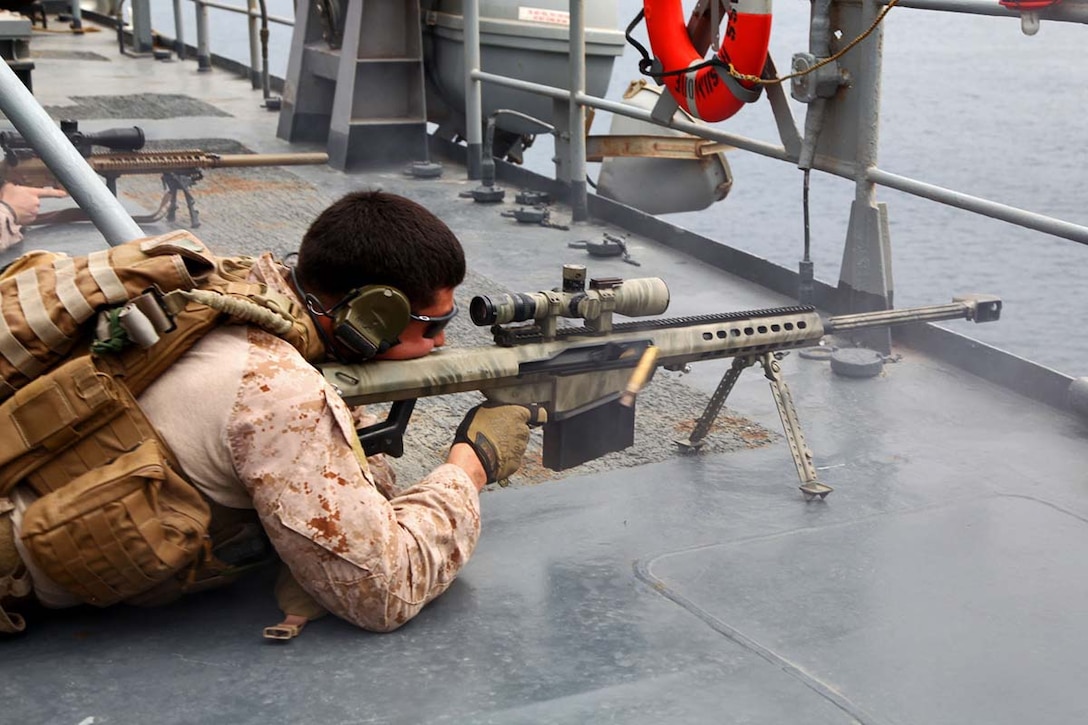 Corporal Diego Oropeza, scout sniper, Scout Sniper Platoon, Weapons Company, Battalion Landing Team 3/5, 15th Marine Expeditionary Unit, fires an M107 Sniper Rifle at a floating  target while conducting Maritime Interoperability Training aboard the USS Rushmore, Feb. 25. The 15th MEU is deployed as part of the Peleliu Amphibious Ready Group as a U.S. Central Command theater reserve force, providing support for maritime security operations and theater security cooperation efforts in the U.S. 5th Fleet area of responsibility. (U.S. Marine Corps photo by Cpl. Timothy R. Childers/Released)