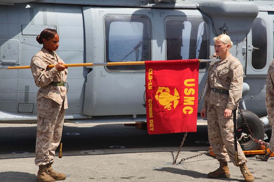 Corporal Shevonne L. Eller (left), food service specialist, Combat Logistics Battalion 15, 15th Marine Expeditionary Unit, and Cpl. Tilor A. Hallquist, a radio operator from the same unit, practice guidon manual during Corporals Course, aboard the USS Rushmore, Feb. 26. The 15th MEU is deployed as part of the Peleliu Amphibious Ready Group as a U.S. Central Command theater reserve force, providing support for maritime security operations and theater security cooperation efforts in the U.S. 5th Fleet area of responsibility. (U.S. Marine Corps photo by Cpl. Timothy R. Childers/Released)