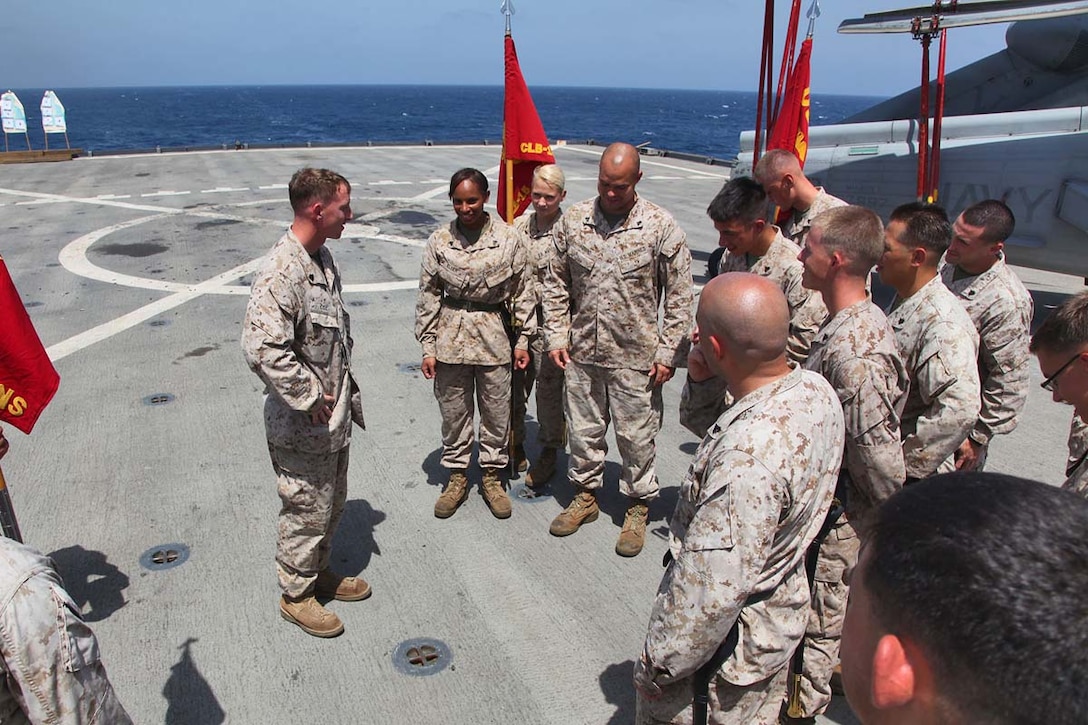 Marines assigned to the 15th Marine Expeditionary Unit practices guidon and sword manual during Corporals Course, aboard the USS Rushmore, Feb. 25. The 15th MEU is deployed as part of the Peleliu Amphibious Ready Group as a U.S. Central Command theater reserve force, providing support for maritime security operations and theater security cooperation efforts in the U.S. 5th Fleet area of responsibility. (U.S. Marine Corps photo by Cpl. Timothy R. Childers/Released)