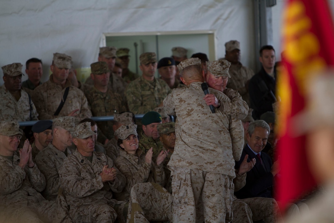 U.S. Marine Corps Maj. Gens. Charles M. Gurganus and Walter L. Miller Jr, commanding generals of I and II Marine Expeditionary Force (Forward), hug during the transfer of authority ceremony to II MEF (FWD) at Camp Leatherneck, Helmand province, Afghanistan, Feb. 28, 2013. The I MEF (FWD) redployed back to Camp Pendleton, Calif., after a year of fighting the insurgency and transitioning the fight to Afghan-led operations. (U.S. Army photo by Bill Putnam/Released)