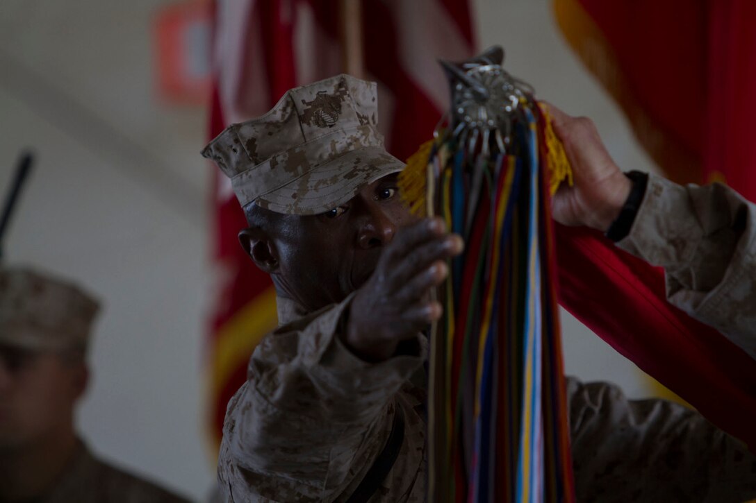 U.S. Marine Corps Sgt. Maj. Harrison Tanksley, sergeant major of the I Marine Expeditionary Force (Forward), cases the colors during the transfer of authority ceremony to II MEF (FWD) at Camp Leatherneck, Helmand province, Afghanistan, Feb. 28, 2013. The I MEF (FWD) redployed back to Camp Pendleton, Calif., after a year of fighting the insurgency and transitioning the fight to Afghan-led operations. (U.S. Army photo by Bill Putnam/Released)